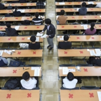 Candidates attend the annual unified college entrance examinations at the University of Tokyo in January. | KYODO