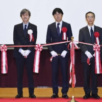 Hironori Fudeyasu (center), head of the Typhoon Science and Technology Research Center, and others attend the center\'s opening ceremony in Yokohama on Oct. 1. | KYODO