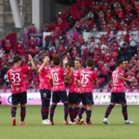 Cerezo players celebrate their win over Urawa on Sunday in Osaka. | KYODO