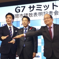 Fukuoka Mayor Soichiro Takashima (left), Fukuoka Gov. Seitaro Hattori (center) and Sumio Kuratomi, head of the Kyushu Economic Federation, hold a news conference in Fukuoka on Monday.  | KYODO