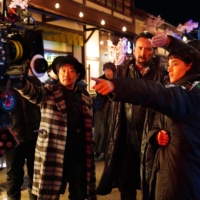 From left: Director Sion Sono, Nicolas Cage and Sofia Boutella on the set of “Prisoners of the Ghostland” | © 2021 POGL SALES AND COLLECTIONS, LLC. ALL RIGHTS RESERVED.
