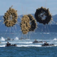 South Korean amphibious assault vehicles sail to shore amid a smokescreen during a media event on Sept. 31, a day ahead of the 73rd anniversary of the country\'s Armed Forces Day, in Pohang, South Korea. | POOL / VIA REUTERS