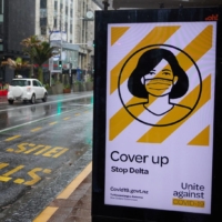 A COVID-19 poster at a bus stop in the central business district in Auckland. | BLOOMBERG 