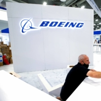 Workers assemble a counter at the Boeing Co. booth at a Las Vegas convention on Oct. 11. | REUTERS