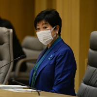 Tokyo Gov. Yuriko Koike listens to infectious disease experts during a weekly coronavirus monitoring meeting Thursday inside the Tokyo Metropolitan Government building. | RYUSEI TAKAHASHI
