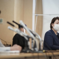 Chiharu Araki, leader of Tomin First, looks on as Tokyo Gov. Yuriko Koike announce her bid for re-election in June 2020 during the runup to the gubernatorial election. | RYUSEI TAKAHASHI
