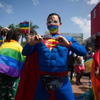 A member of the LGBTQ community dons a Superman at a demonstration in the Dominican Republic. DC Comics recently announced that the new Superman will have a romantic relationship with a male friend. | ERIKA SANTELICES / AFP-JIJI