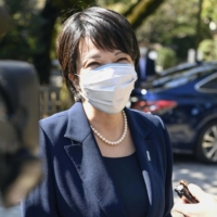 Sanae Takaichi speaks to reporters after visiting Yasukuni Shrine in Tokyo on Monday. | KYODO