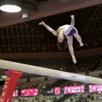 Mai Murakami competes on the balance beam during preliminaries at the Artistic Gymnastics World Championships on Monday in Kitakyushu. | KYODO
