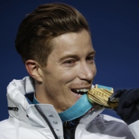 American snowboarder Shaun White celebrates his gold medal after the men\'s halfpipe final at the 2018 Winter Olympics in Pyeongchang, South Korea. | MEDALS CEREMONY - SNOWBOARDING - PYEONGCHANG 2018 WINTER OLYMPICS - MEN\'S HALFPIPE - MEDALS PLAZA - PYEONGCHANG, SOUTH KOREA - FEBRUARY 14, 2018 - GOLD MEDALIST SHAUN WHITE OF THE U.S. ON THE PODIUM. REUTERS/KIM HONG-JI
PYEONGCHANG 2018 WINTER OLYMPICS