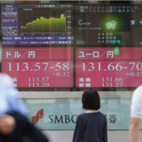 A stock board outside the head office of SMBC Nikko Securities Inc. in Tokyo on Oct. 14 | BLOOMBERG
