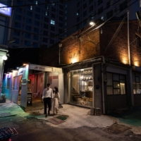 Customers exit a cafe in the Sindang neighborhood in Seoul.  | BLOOMBERG 