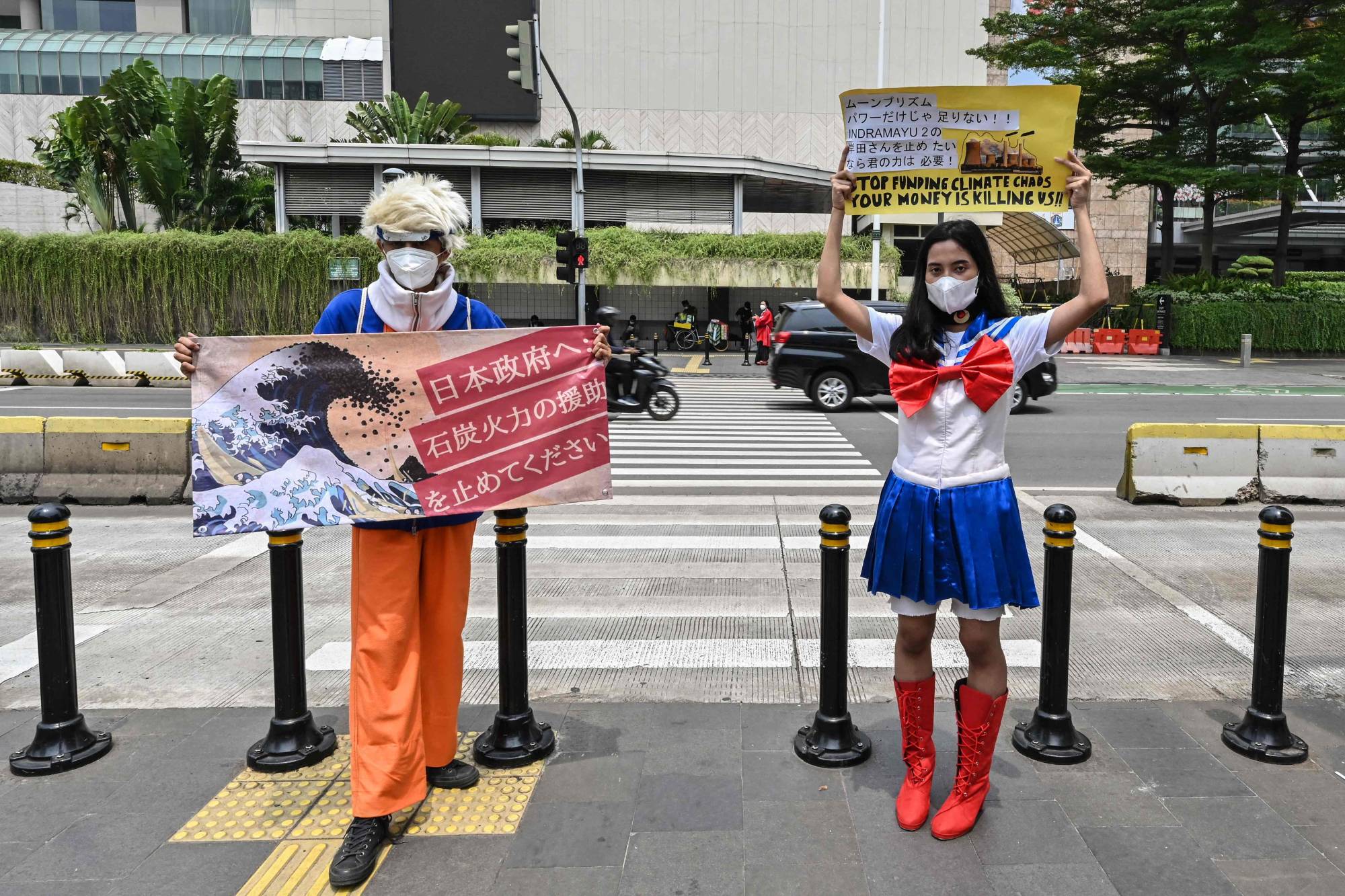 Environmental activists demanding that Japan stop funding a coal-fired power station in Indramayu, Indonesia, protest near the Japanese Embassy in Jakarta on Oct. 4, as part of global protests ahead of COP26. | AFP-JIJI