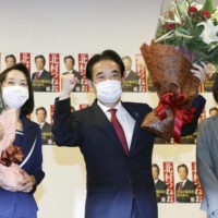 Liberal Democratic Party candidate Tsuneo Kitamura celebrates after winning a House of Councillors by-election in Yamaguchi Prefecture on Sunday. | KYODO