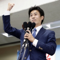 Shinnosuke Yamazaki, who was supported by the opposition Constitutional Democratic Party of Japan and the Democratic Party for the People, celebrates in the city of Shizuoka on Sunday after winning a House of Councilors by-election in Shizuoka Prefecture. | KYODO