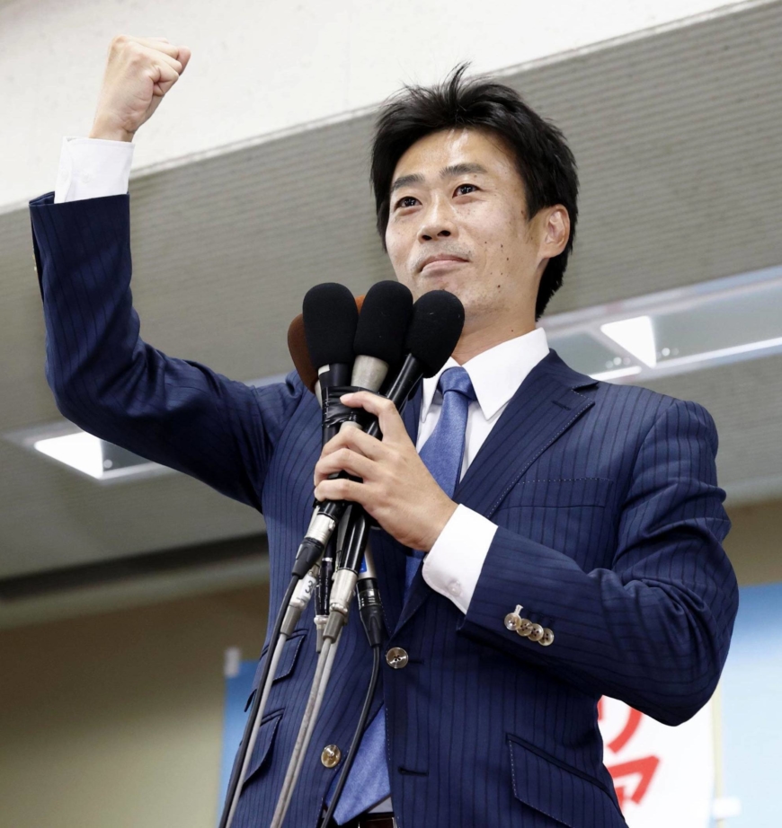 Shinnosuke Yamazaki, who was supported by the opposition Constitutional Democratic Party of Japan and the Democratic Party for the People, celebrates in the city of Shizuoka on Sunday after winning a House of Councilors by-election in Shizuoka Prefecture. | KYODO