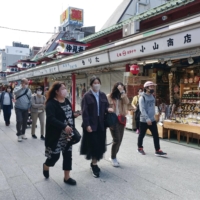 People visit Tokyo\'s Asakusa area on Monday. | KYODO