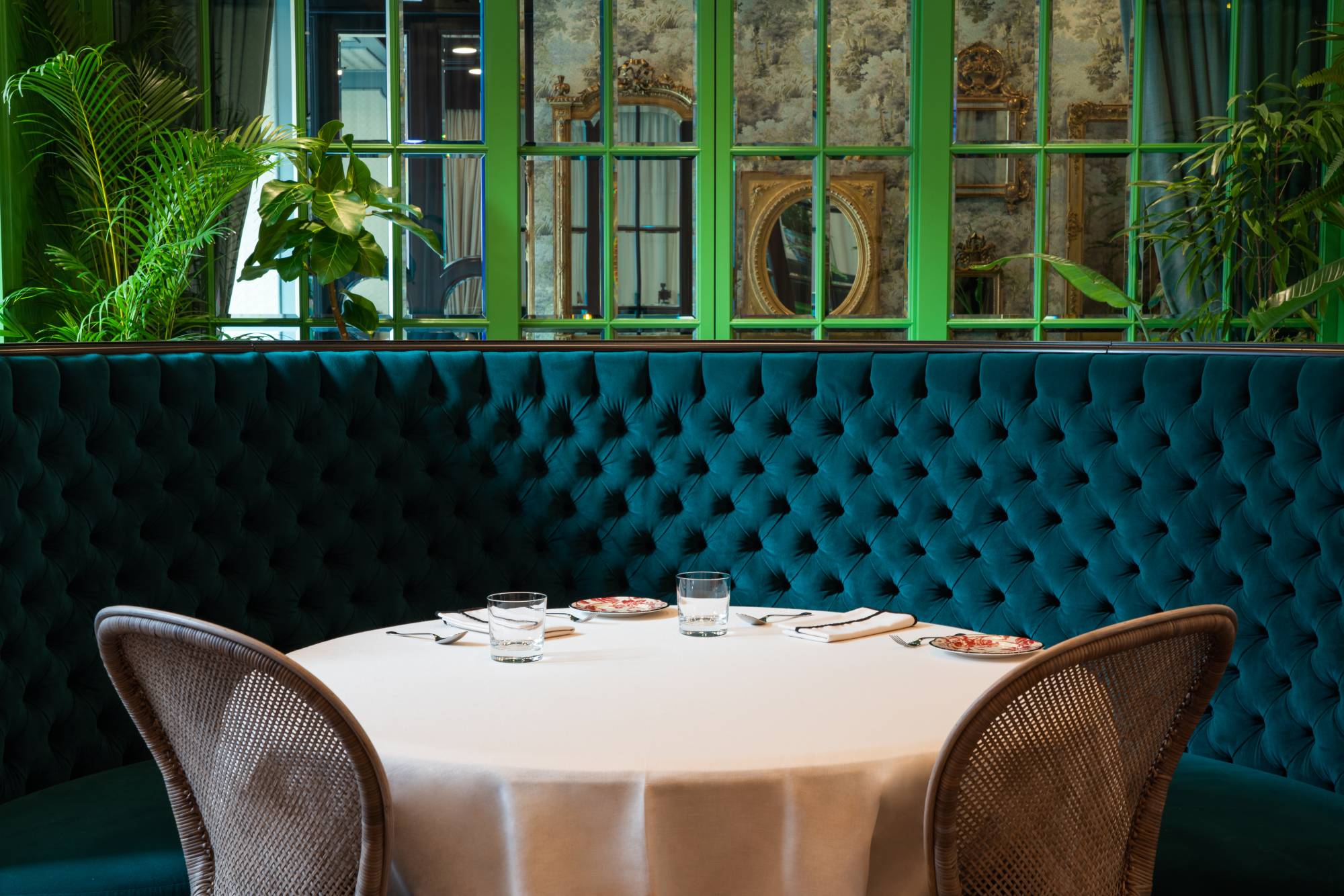 The dining room at Gucci Osteria Tokyo is painted a vibrant olive green and decorated with antique mirrors. | Hiroki Kobayashi 