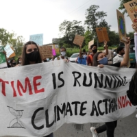 People hold banners and signs as they take part in a \"Fridays for Future\" march calling for urgent measures to combat climate change, in New Delhi, India. | REUTERS