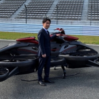 A.L.I. Technologies\' Chief Executive Daisuke Katano poses next to the XTurismo Limited Edition hoverbike during a demonstration at Fuji Speedway in Oyama, Shizuoka Prefecture, on Tuesday. | REUTERS