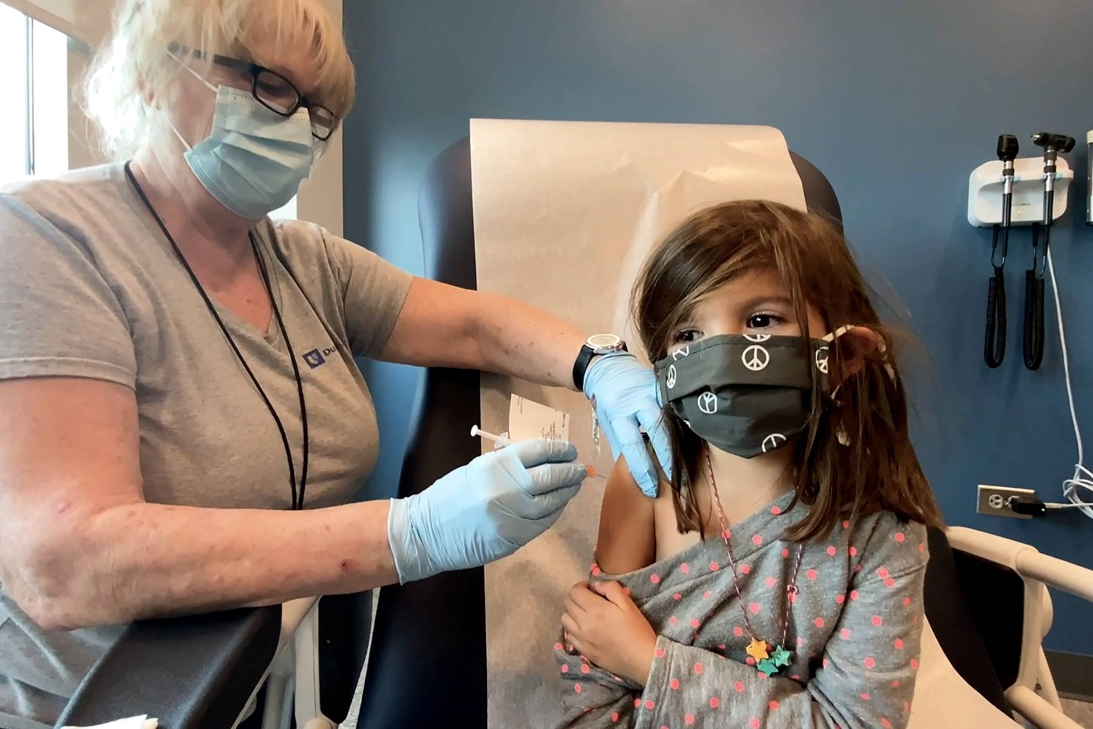 A 5-year-old girl prepares to receive a reduced dose of the Pfizer-BioNtech COVID-19 vaccine during a trial at Duke University in Durham, North Carolina, on Sept. 28. | DUKE UNIVERSITY / VIA REUTERS
