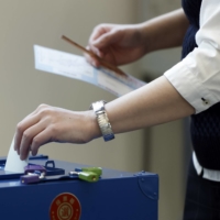 A voter casts a ballot at an early polling location in the Minato Ward of Tokyo on Thursday. | BLOOMBERG