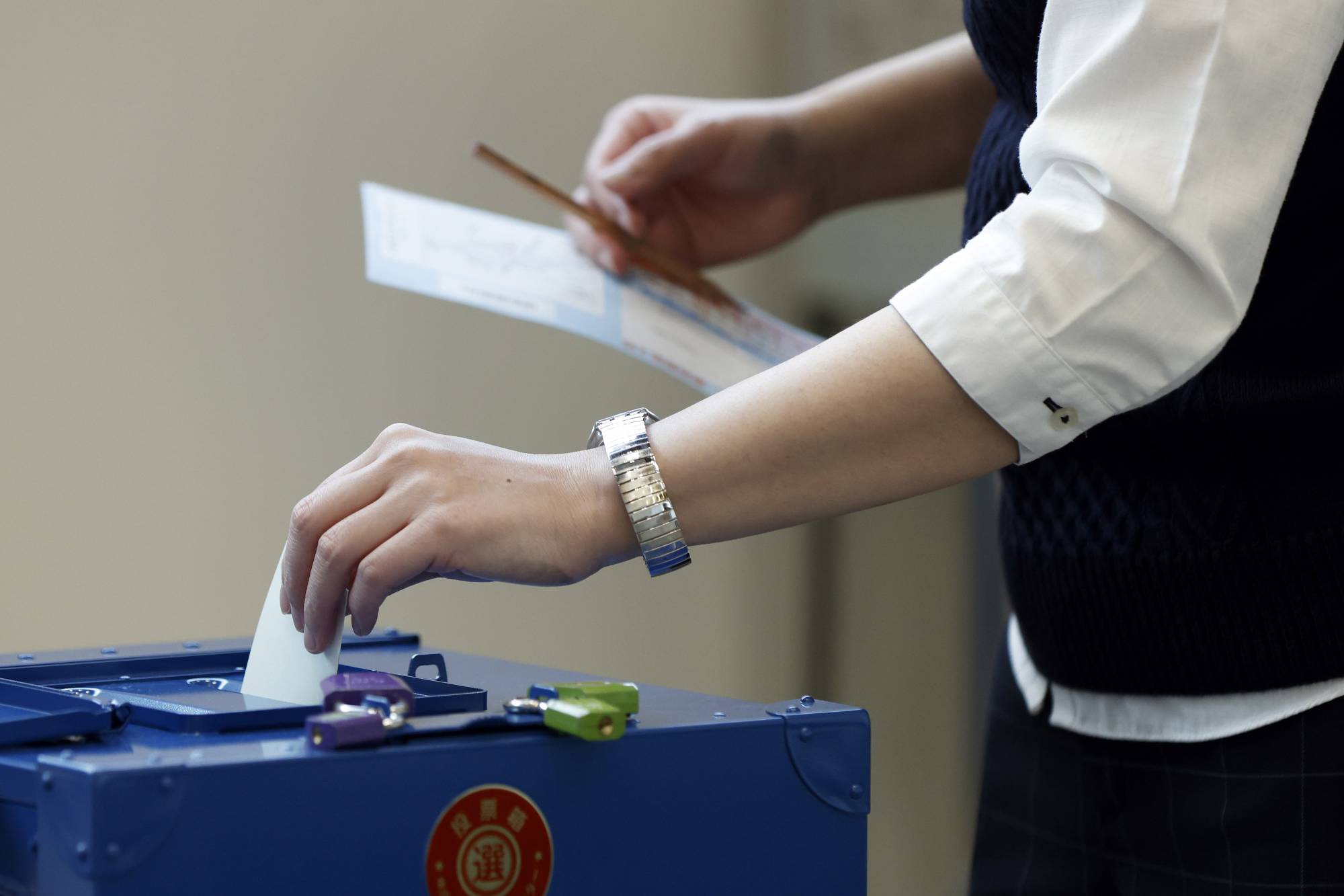 A voter casts a ballot at an early polling location in the Minato Ward of Tokyo on Thursday. | BLOOMBERG