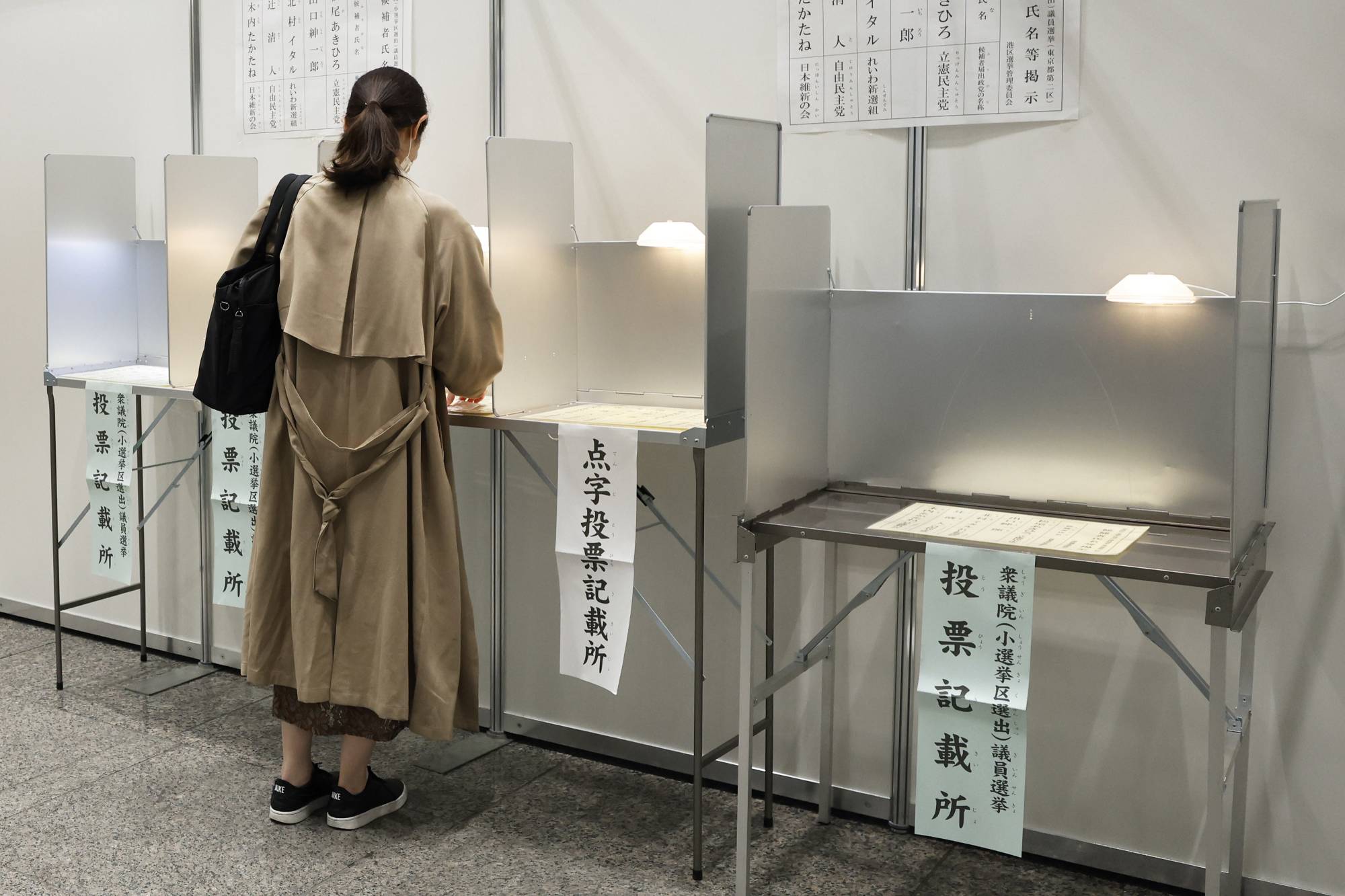 A voter casts a ballot at an early polling location in the Minato Ward of Tokyo on Thursday. | BLOOMBERG