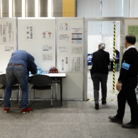 People cast their votes at an early polling location in Tokyo\'s Minato Ward on Thursday.  | BLOOMBERG