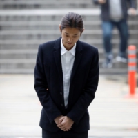 South Korean singer Jung Joon-young arrives at the Seoul Central District Court in 2019. He is currently serving a five-year prison term for sexual assault and distributing videos of his victims. | REUTERS