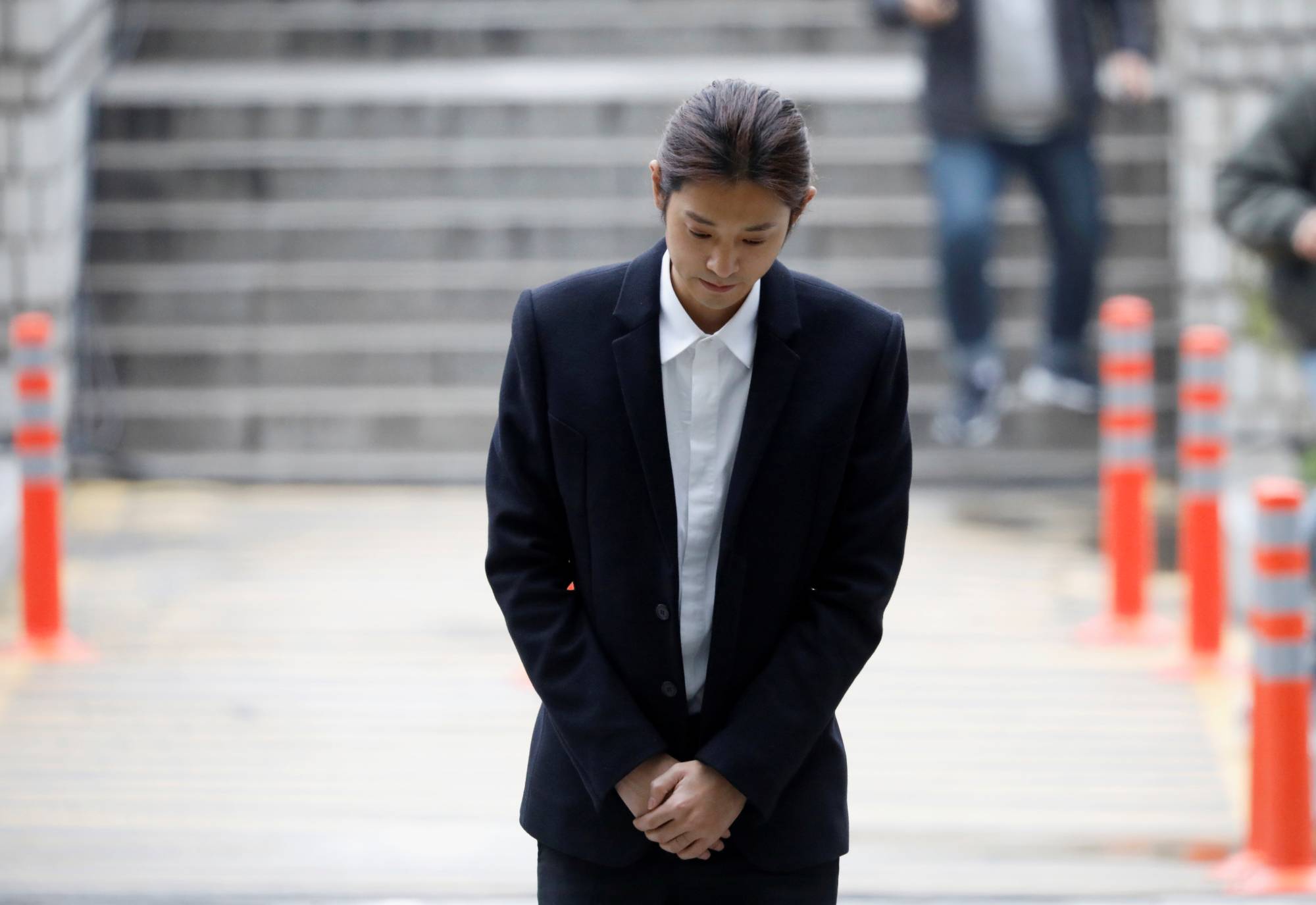 South Korean singer Jung Joon-young arrives at the Seoul Central District Court in 2019. He is currently serving a five-year prison term for sexual assault and distributing videos of his victims. | REUTERS
