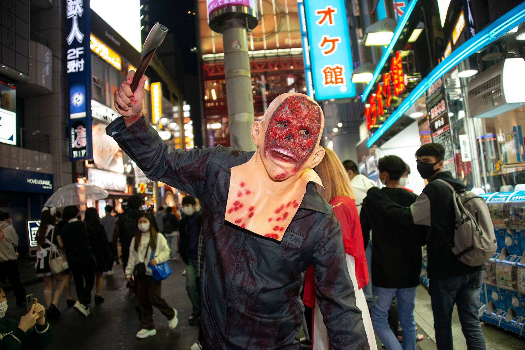 'Sekiya,' 27, poses on a shopping street in Shibuya on Halloween night. As for the election? 'I have zero interest,' Sekiya says, adding that he never votes. 'There's really no benefit in voting. Nothing changes.' | ROB GILHOOLY