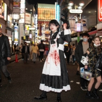 \"Aoki,\" 24, poses on a shopping street in the Shibuya district on Halloween night. Asked if he had voted during the general election, Aoki says he couldn\'t. \"I\'m a foreign student, from China.\" Only Japanese citizens — including those born outside Japan but who have taken up Japanese citizenship — are allowed to vote in Japan. | ROB GILHOOLY