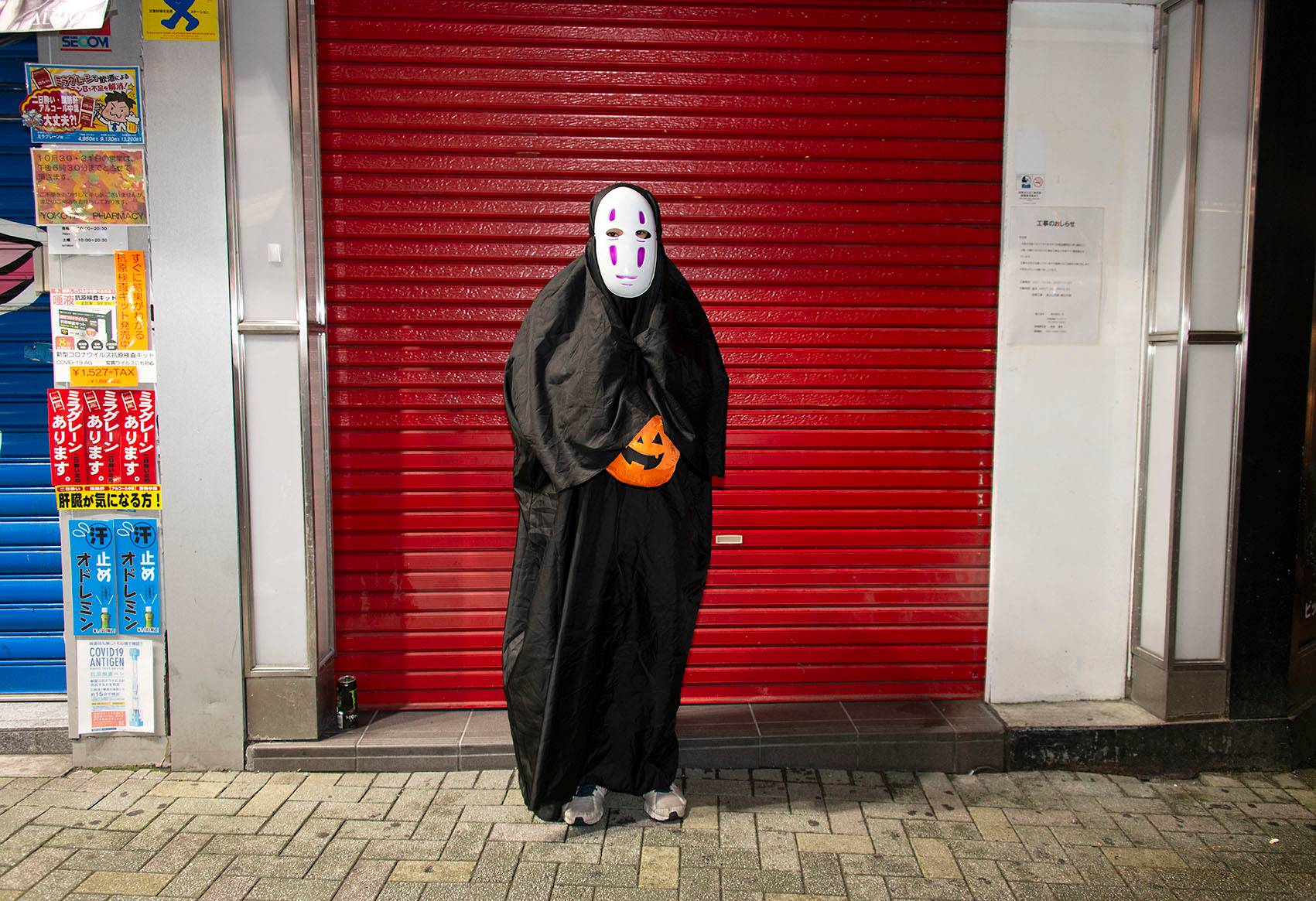 'Suzuki,' who is in his early 30s, takes a break from the crowds during Halloween celebrations in Shibuya, Tokyo, on Sunday. He says he is 'indifferent' about politics. 'I pay no attention to the elections,' he says. 'Many young people don’t bother. The outcome is pretty much set in stone anyway. My friends and colleagues, we never talk politics. We couldn't care less.' | ROB GILHOOLY