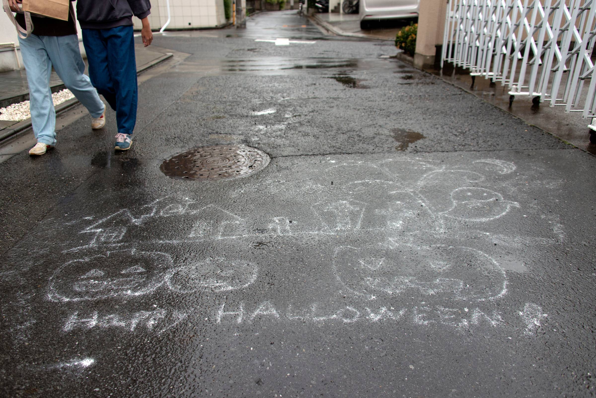 Pedestrians walk past a “Happy Halloween” message written with chalk on the asphalt in Setagaya Ward, Tokyo. This year, Halloween and a major election ended up sharing a date. Turnout among Japan's youth was expected to be lower than the 31% in the 2019 Upper House election — a far cry from countries such as Denmark, where it is around 80%. In the United States, around 50% of 18- to 29-year-olds voted in the 2020 presidential election — an 11-point increase over the 2016 ballot. | ROB GILHOOLY