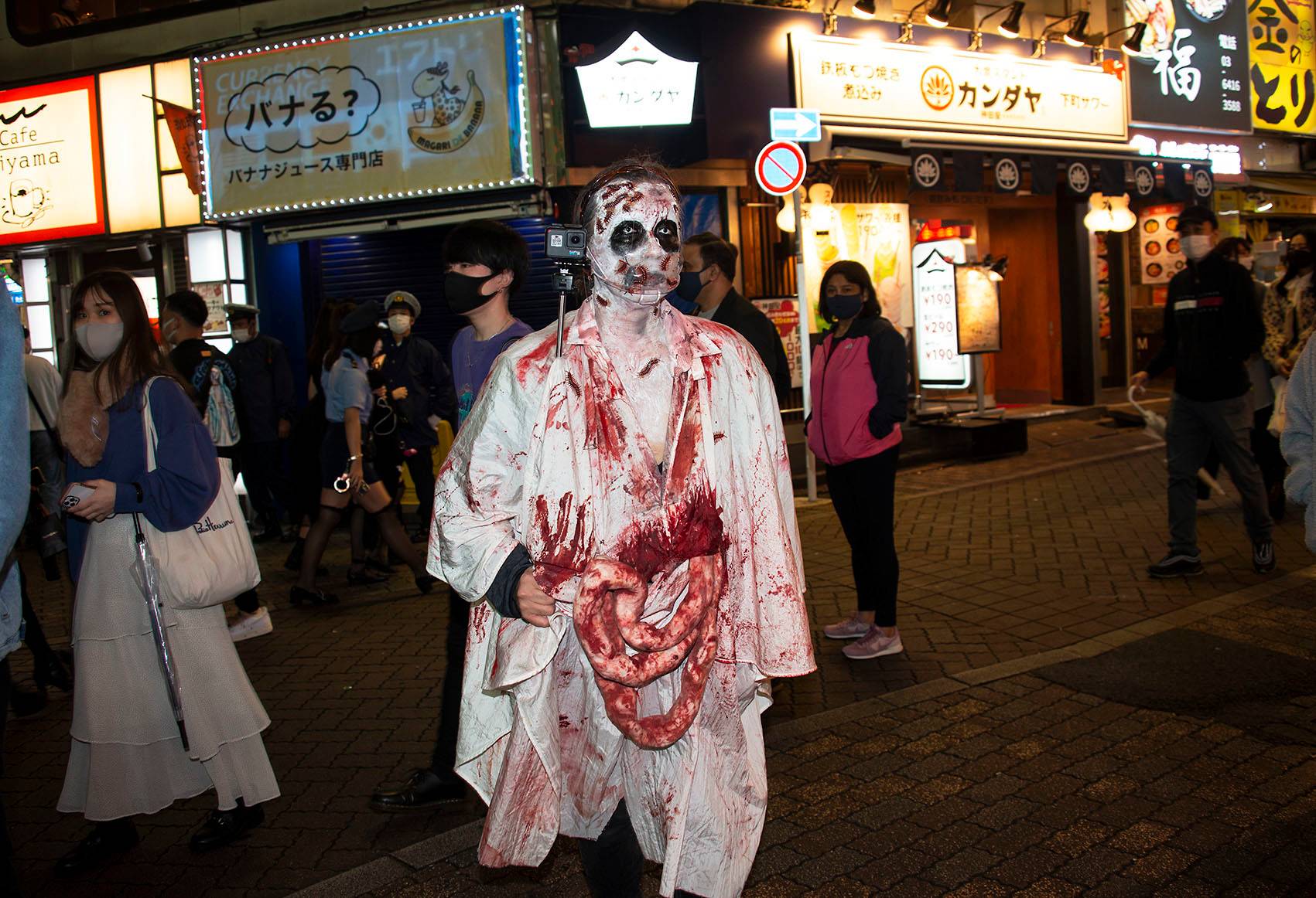 A reveler dressed up in zombie attire lets it all hang out on Sunday. | ROB GILHOOLY