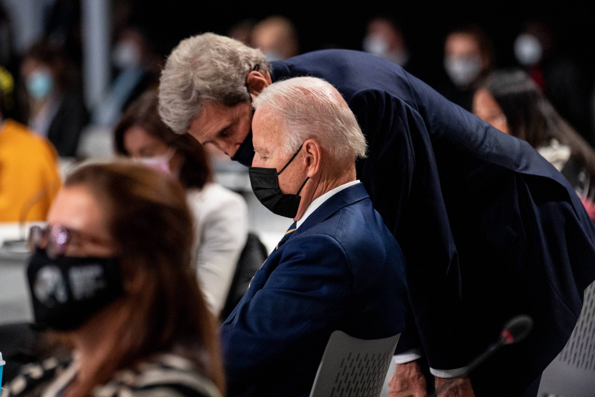 U.S. President Joe Biden talks with U.S. climate envoy John Kerry at the COP26 summit in Glasgow, Scotland, on Monday. | Erin Schaff / The New York Times