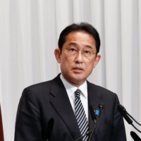 Prime Minister Fumio Kishida speaks during a news conference at Liberal Democratic Party  headquarters in Tokyo on Monday. Kishida vowed to act fast on his economic program after a surprisingly robust election win, saying he would seek to pass an extra budget as soon as possible and make clean energy investment a priority.  | BLOOMBERG