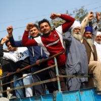 Farmers arrive in a tractor at the site of a protest against farm laws near New Delhi in January.  | REUTERS 