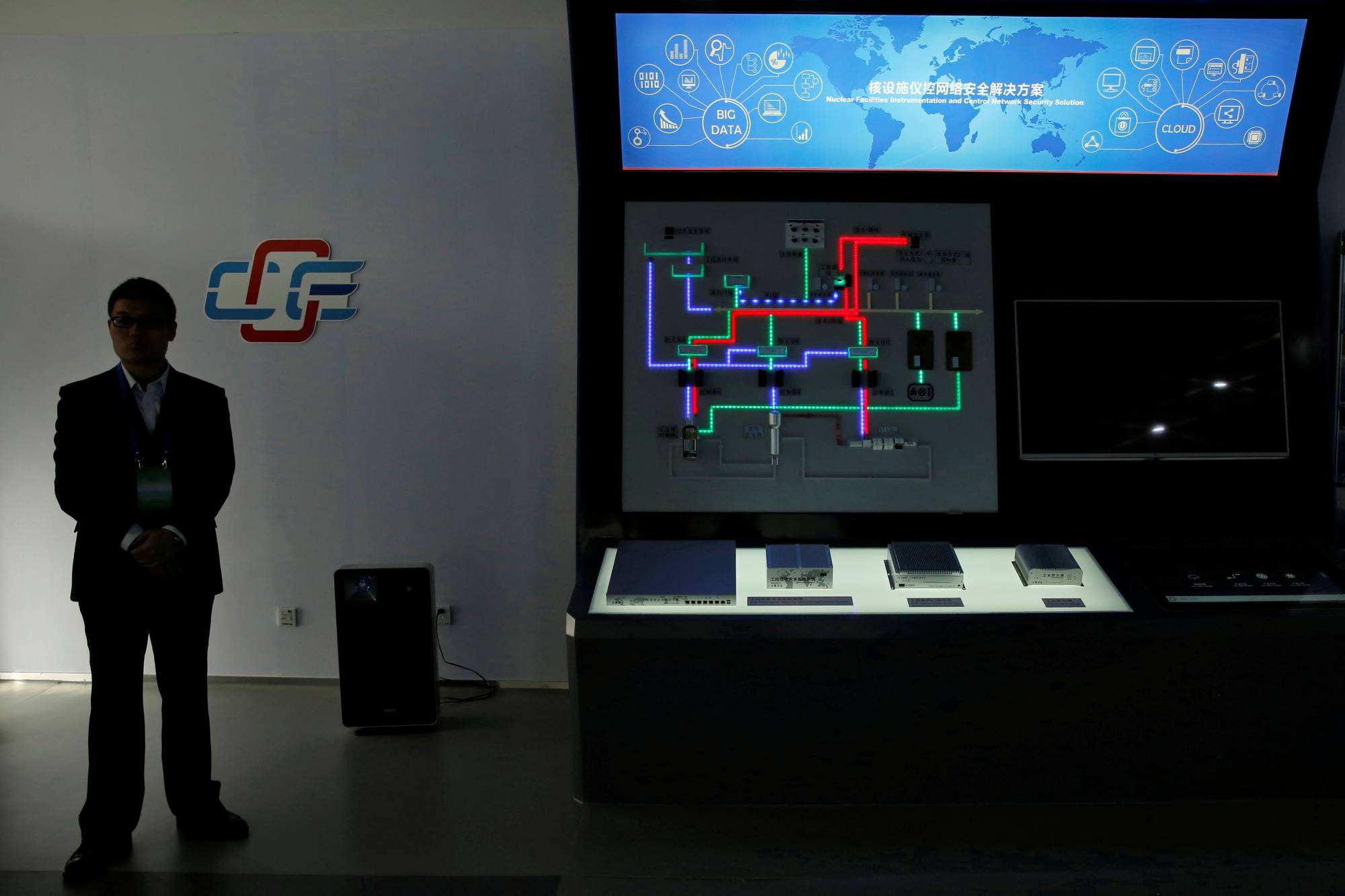 A staff member stands next to a display of nuclear facilities instrumentation and control network security solution at a Center of Excellence on Nuclear Security exhibition hall at the State Nuclear Security Technology Center in Beijing in March 2016.  | REUTERS