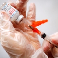 A health care worker prepares a syringe with the Moderna COVID-19 vaccine at a pop-up vaccination site in New York City in January 2021. | REUTERS
