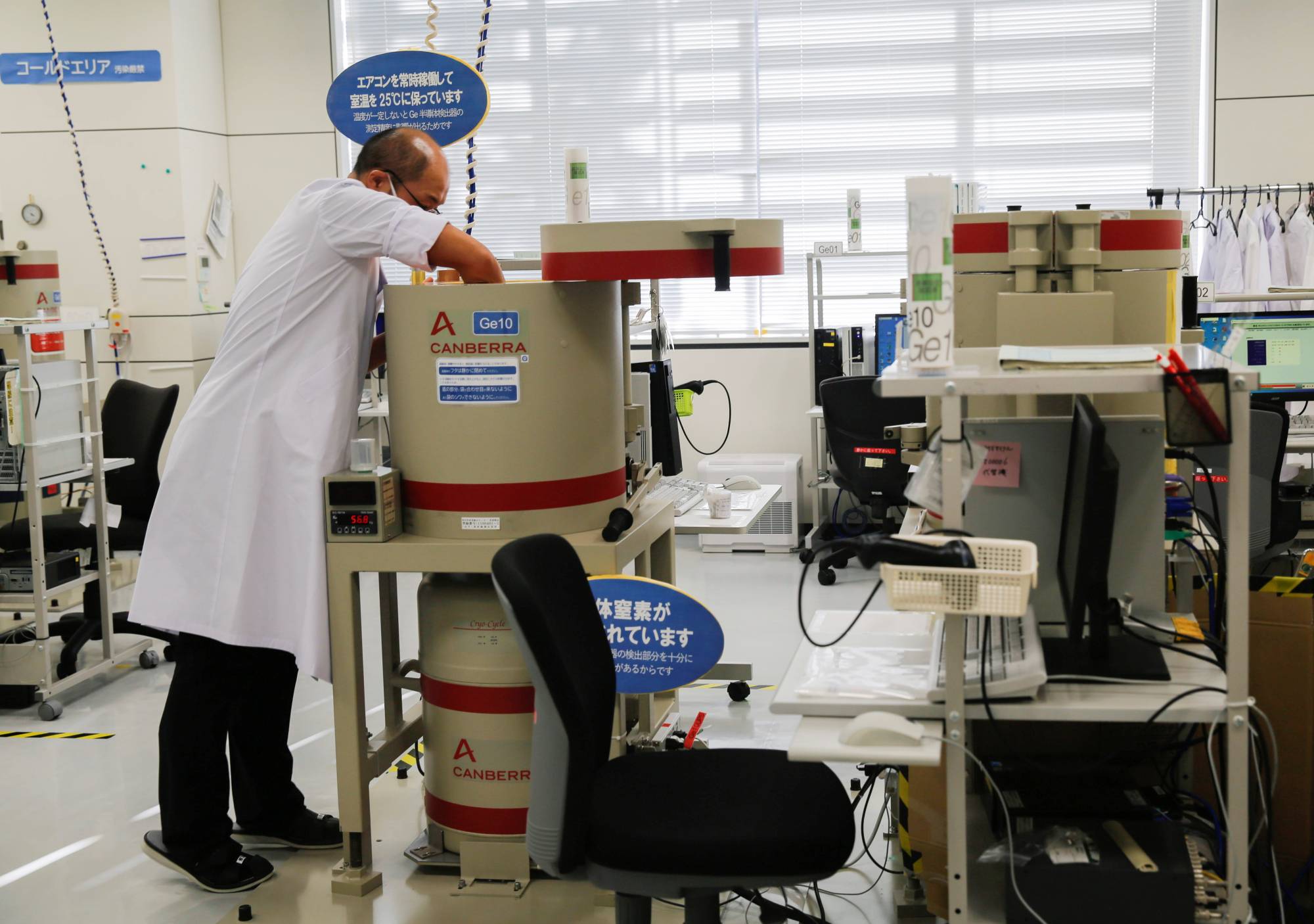 A laboratory technician prepares tests for cesium levels in beef from cattle bred in Fukushima, at Fukushima Agricultural Technology Center in Koriyama on Tuesday. | REUTERS