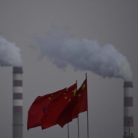 Chinese national flags flutter in front of a coal-fired power station in Datong, China, on Wednesday. | AFP-JIJI