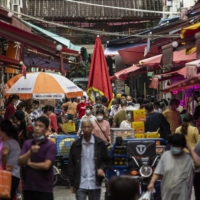 Shoppers walk through a wet market in Guangzhou, China, on Oct. 14.  | BLOOMBERG