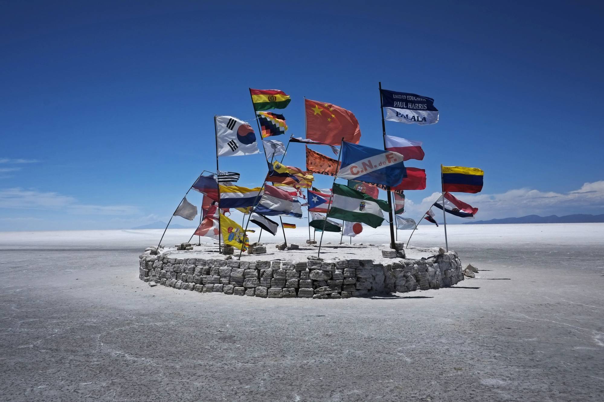 Flags of different countries fly above Bolivia's Uyuni salt lake, which holds the world's largest reserve of lithium. | REUTERS 