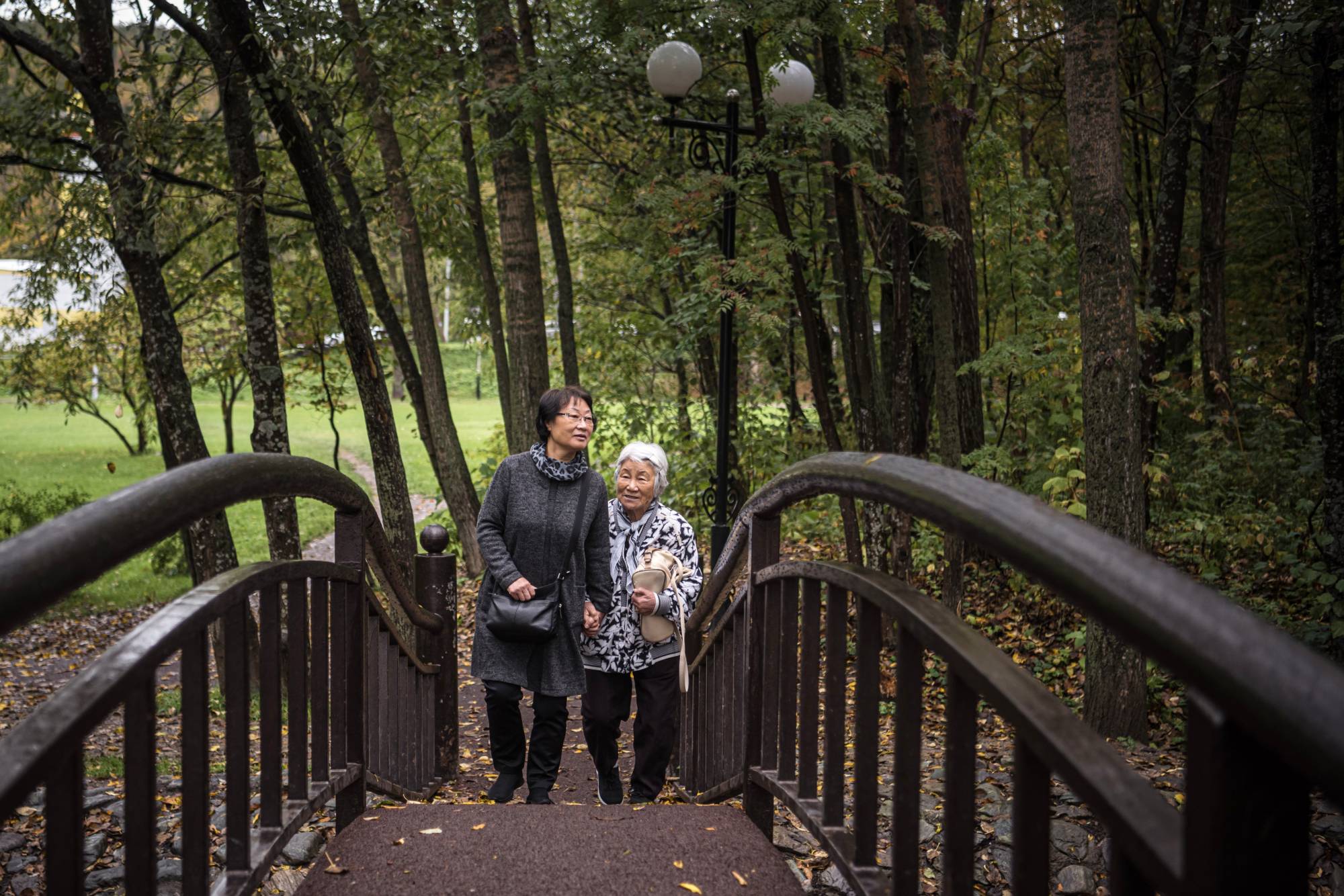 Kim Geum-hee and her mother Taeko Nisio, who will both soon move to South Korea, walk in a park in Yuzhno-Sakhalinsk, Russia, on Oct. 4 on the island of Sakhalin, on Russia’s eastern edge. | Sergey Ponomarev/The New York Times