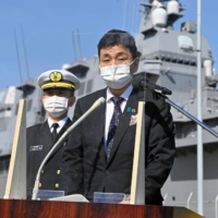 Defense Minister Nobuo Kishi speaks to reporters after inspecting the Maritime Self-Defense Force\'s Izumo helicopter carrier in Yokosuka, Kanagawa Prefecture, on Monday. | POOL / VIA KYODO