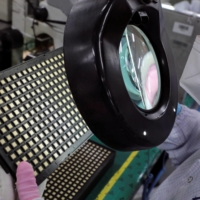 A worker inspects semiconductor chips at a chip packaging plant in Ipoh, Malaysia, on Oct. 15. | REUTERS