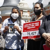 Sisters of Ratnayake Liyanage Wishma Sandamali, a Sri Lankan woman who died in March 2021 following mistreatment at a Japanese immigration center, speak to reporters in Tokyo on Sept. 10. | KYODO