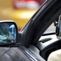 A taxi driver uses the Didi Chuxing car-hailing app in Beijing. | REUTERS 